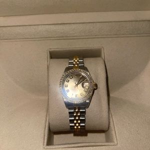 Women’s 26mm Rolex with diamond bezel.